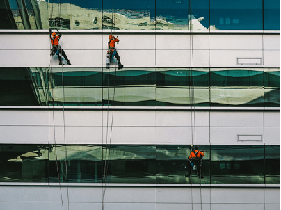 Workers cleaning the exterior of a building