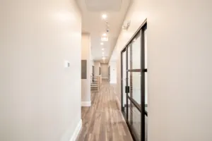 Renovated office corridor with glass-walled rooms