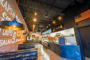 Professionally cleaned dining area at a bagel shop, with view of the food counter