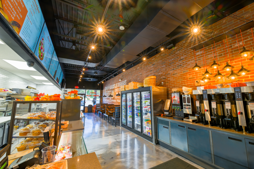 Professionally cleaned bagel shop with view of the coffee and condiment counter and entrance