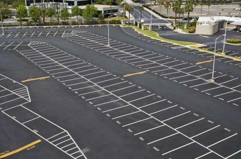 Commercial parking lot with repaired asphalt and painted spaces
