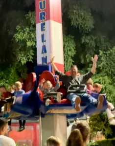 Guests riding the Fireball attraction at Adventureland